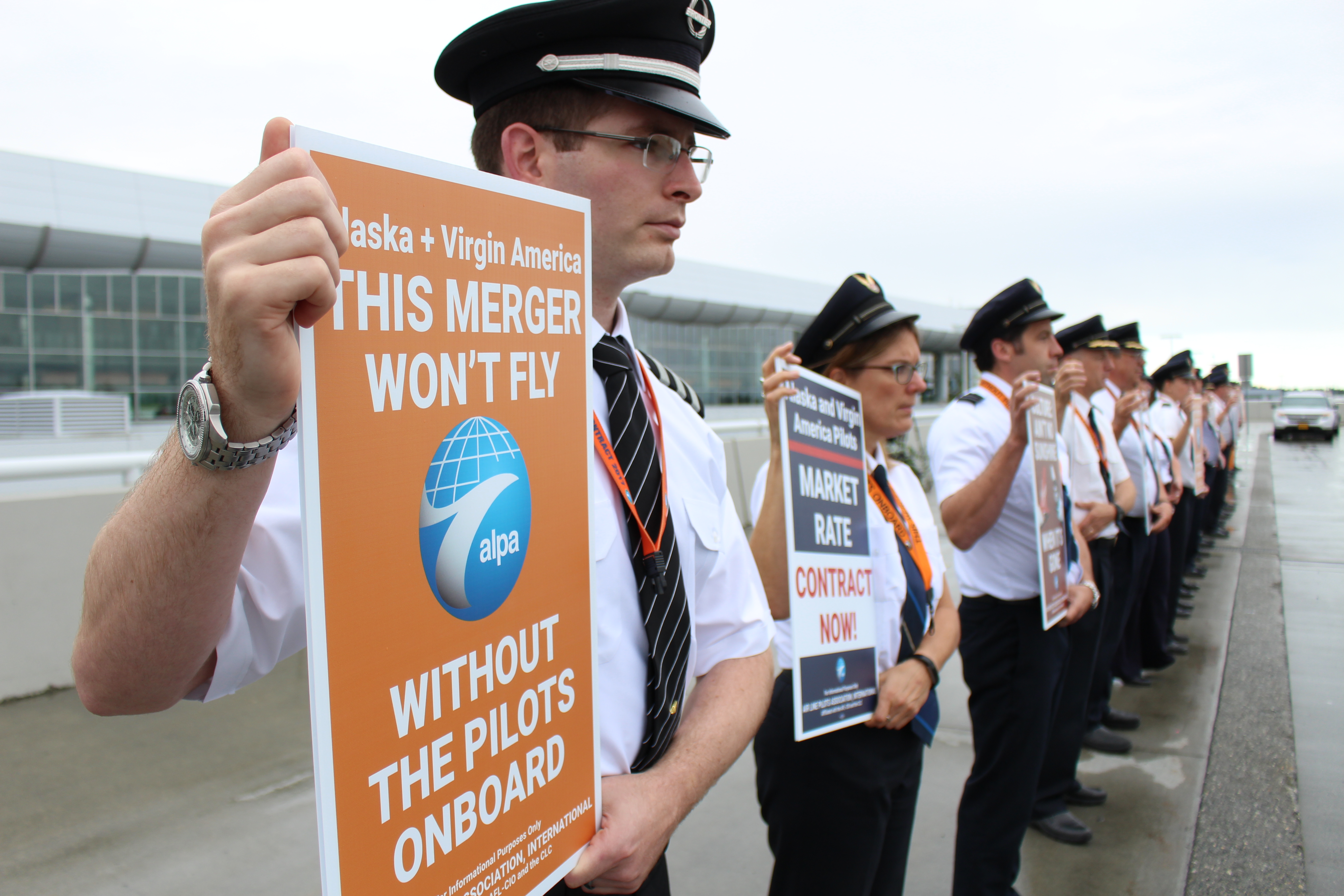 Pilots picket in front of Ted Stevens International Airport in support of Alaska Airlines’ pilots request for a new contract. (Photo by Wesley Early/Alaska Public Media)