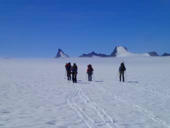 Part of the mass balance group skiing to their pit located behind Emperor Peak. (Photo by Julian Cross, courtesy JIRP)