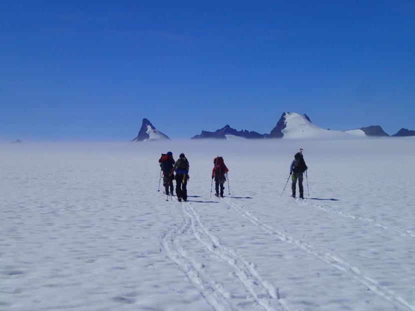 Part of the mass balance group skiing to their pit located behind Emperor Peak. (Photo by Julian Cross, courtesy JIRP)