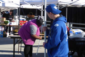 A Falcons football player helps carry a pavilion at the Juneau Maritime Festival.