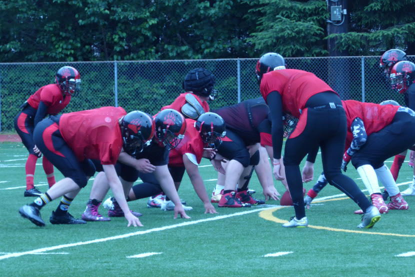 The Crimson Bears offense and defense face off at a summer practice.