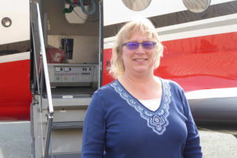 Shelly Deering the Alaska Regional Manager for Airlift Northwest stands in front of the newest Airlift Northwest plane, a pilatus.