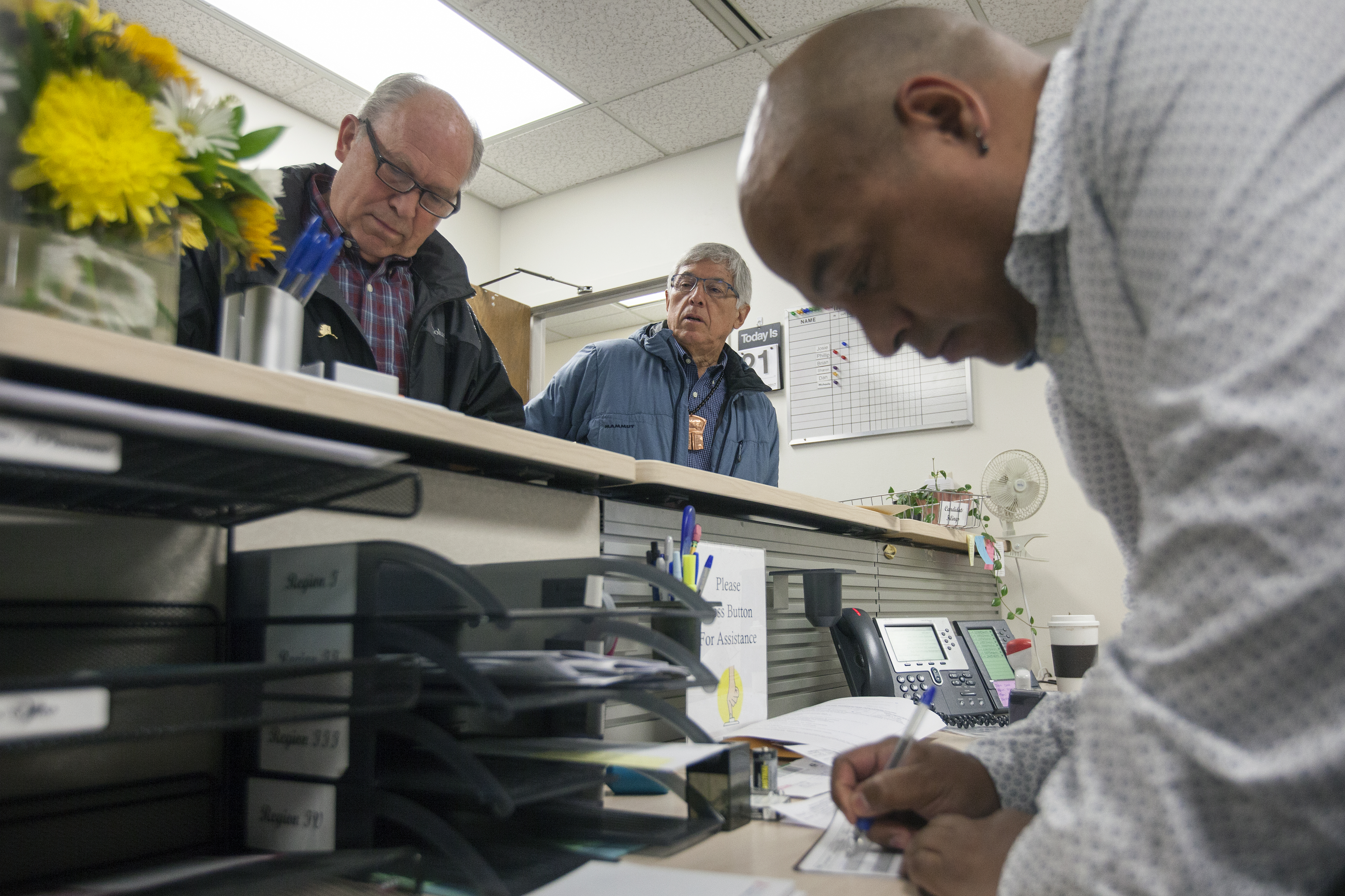 Alaska Gov. Bill Walker and Lt. Gov. Byron Mallott file for re-election with Daniel Ruiz, an administrative assistant with the Division of Elections, on Monday, August 21, 2017, in Juneau, Alaska. The two are filing as unaffiliated candidates -- though Mallott maintains his personal affiliation with the Democratic party. (Photo by Rashah McChesney/Alaska's Energy Desk)
