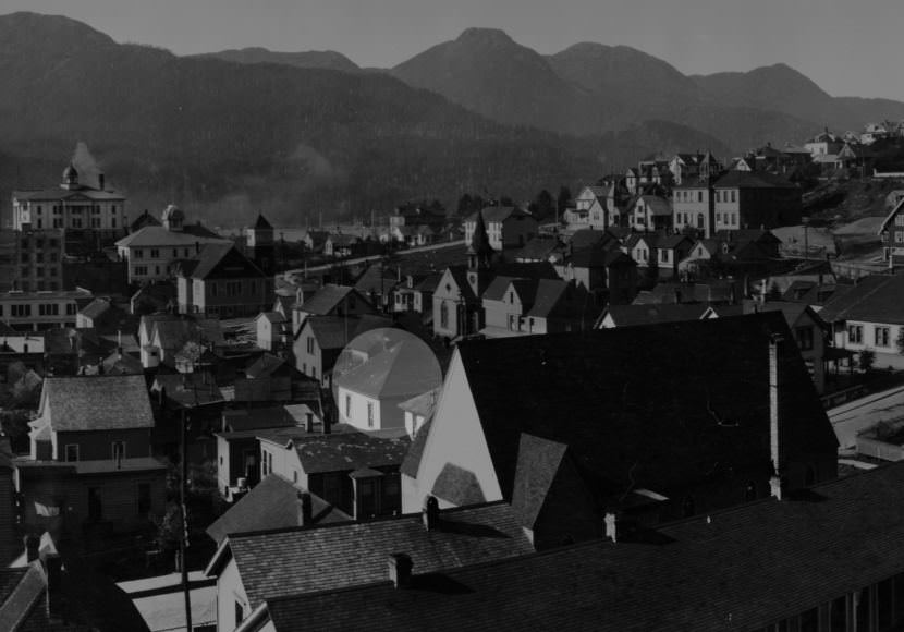 Portion of a panoramic photo taken by Winter & Pond in 1916 at the corner of Third and Harris streets shows the old Church of the Holy Trinity in the foreground. The church's cross gable roof partially obscures the possible residences of Charles Damer and William Dickinson on Fourth Street. The highlighted structure may be the cottage where Charles Damer was murdered. Although the hip roof is identical to the roof of the existing structure at 325 Fourth Street, the ridge line runs in a different direction. (ASL-P87-1-002)