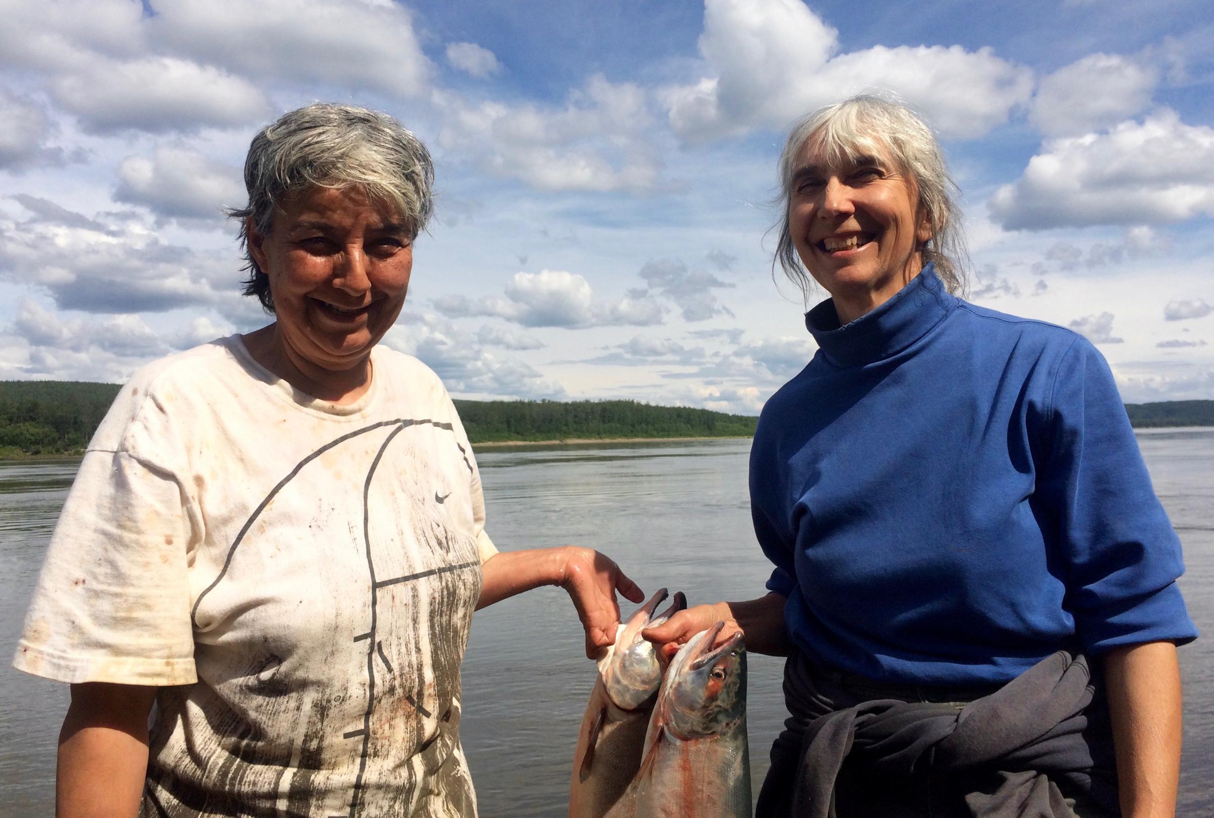 Maggie Bobby, left, and Barb Carlson have run a fish wheel near Sleetmute since 2015. (Photo by Anna Rose MacArthur/KYUK)