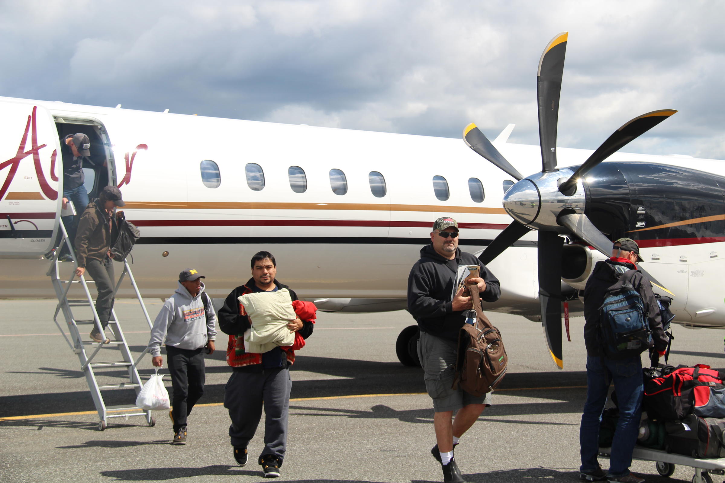 PenAir customers coming into Bristol Bay for the summer, deplaning one of the new Saab 2000s in King Salmon in June. (Photo by KDLG)