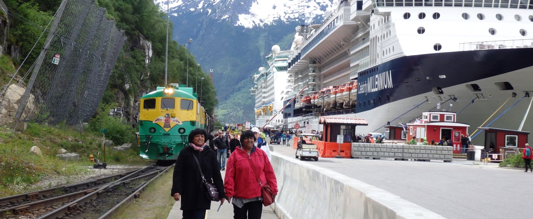 Tourists walk on Skagway’s railroad dock in summer of 2016. The cliff, where a rockslide occurred Aug. 26, is adjacent to Skagway’s biggest cruise ship dock. (Photo by Emily Files/KHNS)