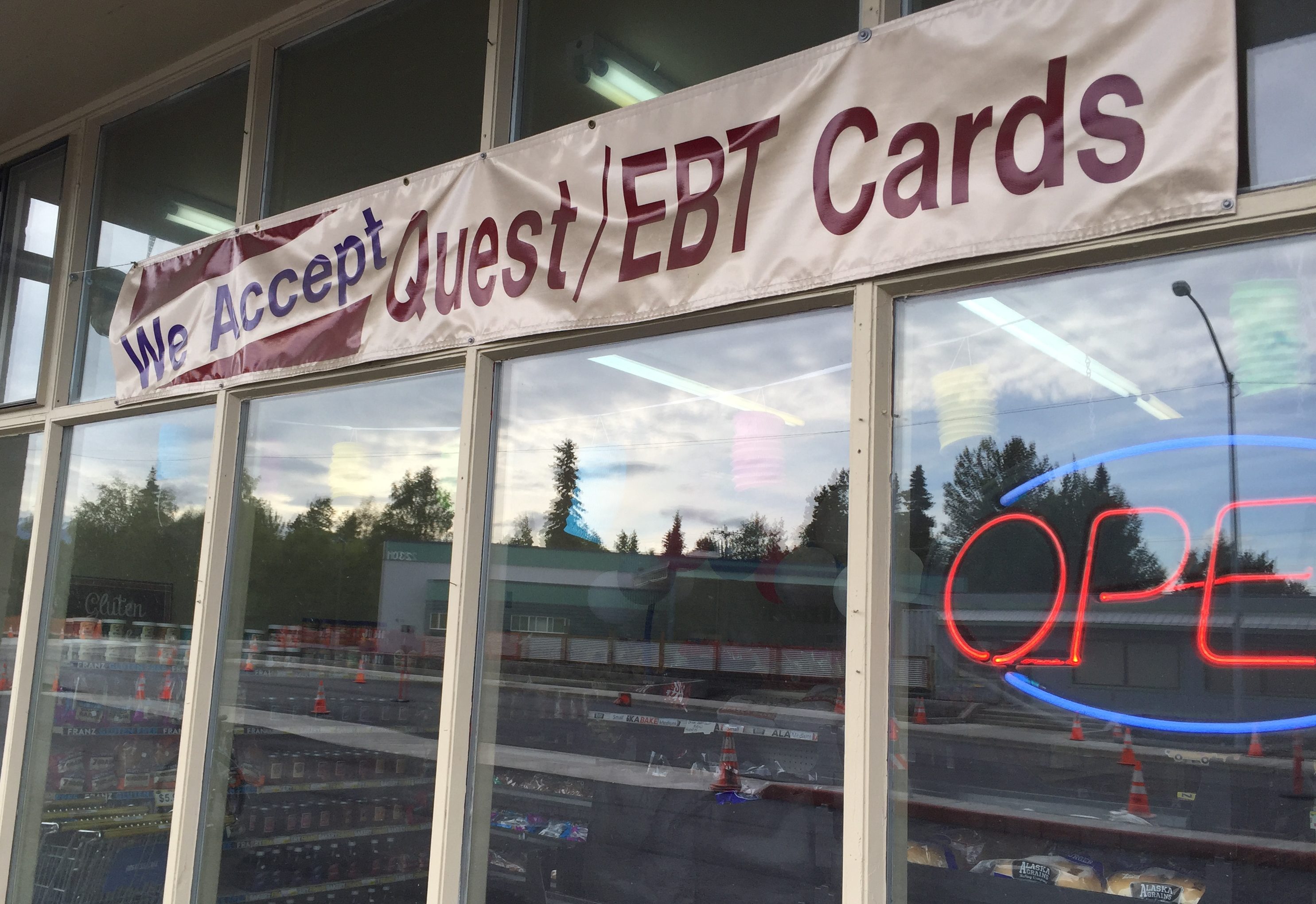 A sign outside of a store in midtown Anchorage announcing that they accept EBT Cards, the distribution method for SNAP benefits. (Photo by Hillman/Alaska Public Media)