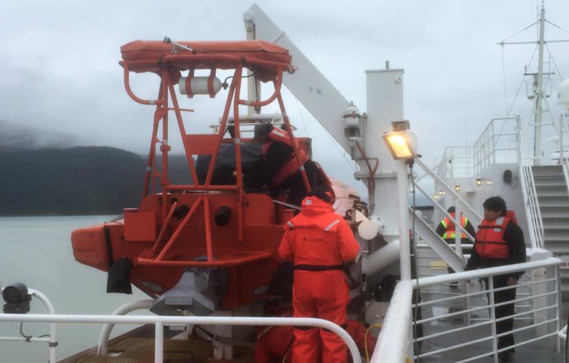 Crew members wrap up a safety drill on the deck of the ferry Malaspina during a sailing from Juneau to Haines Sept. 18, 2017. The ferry system faces changes to its fleet as part of a larger reform plan. (Photo by Ed Schoenfeld/CoastAlaska News)