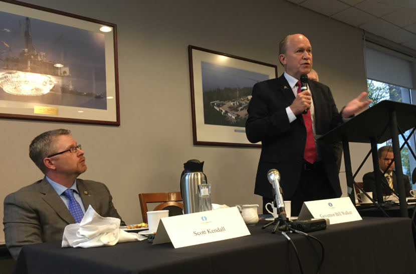 Gov. Bill Walker's chief of Staff Scott Kendall, left, listens as Walker speaks to Commonwealth North in Anchorage. Walker said a broad-based tax is needed. (Photo by Andrew Kitchenman/KTOO)