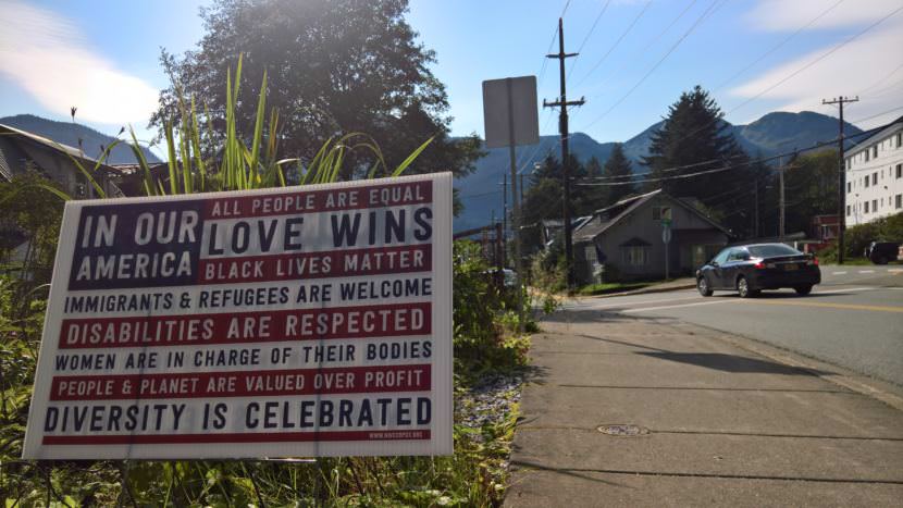 A motorist passes a yard sign in the Flats neighborhood of downtown Juneau that celebrates diversity on Tuesday, Sept. 5, 2017.