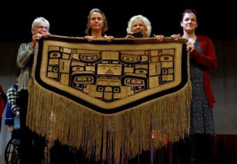 At least four generations of the Davenport family have grown up with the “Diving Whale” blanket. But, as Amy Davenport told the audience Sept. 14, “There came a time when this blanket needed to come back.” (Photo courtesy James Poulson/Daily Sitka Sentinel)