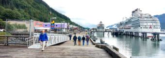 A pair of Panamax cruise ships docked in downtown Juneau on Aug. 30, 2017. The floating berths have eliminated the need for yellow security fencing and opened up a wide promenade for pedestrians. (Photo by Jacob Resneck/KTOO)