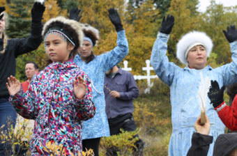 The Igyararmiut, the residents of Igiugig, perform a traditional blessing dance. (Photo by Avery Lill/KDLG)