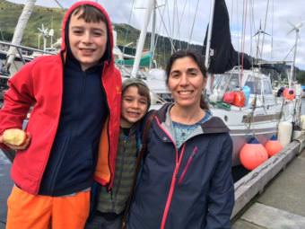 Elias, 11, left, snacks on an apple before going off to a cross country race with his brother Eric, 7, and mom Alisa Abookire. Along with their boys' dad, Mike Litzow, returned to Kodiak after roughly 10 years of sailing the world. (Photo by Kayla Desroches/KMXT)
