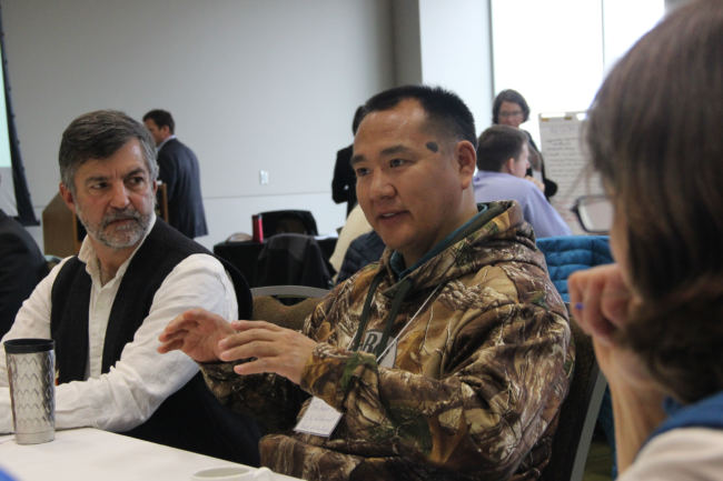 John Hopson, Jr., (r) of Wainright and Rand Hagenstein (l) of The Nature Conservancy joined representatives from oil and gas, mining, environmental groups and local communities at the Walker administration's climate change round table in Anchorage on Oct. 4, 2017. (Photo by Rachel Waldholz/Alaska's Energy Desk)