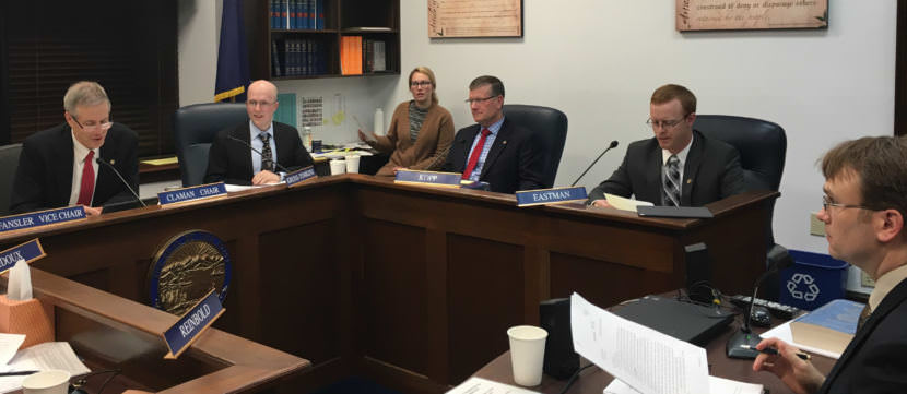 Rep. Matt Claman, D-Anchorage, Rep. Jonathan Kreiss-Tomkins, D-Sitka, Rep. Chuck Kopp, R-Anchorage, and Rep. David Eastman, R-Wasilla, discuss amendments to Senate Bill 54. Criminal Division Director John Skidmore, on the right, is testifying, Oct. 26, 2017. (Photo by Andrew Kitchenman/KTOO)