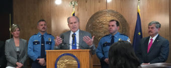 Gov. Bill Walker speaks about his public safety plan. Listening to him are: Alaska Attorney General Jahna Lindemuth, Alaska State Troopers Director Col. Hans Brinke, Alaska Wildlife Troopers Director Col. Steve Hall, and Public Safety Commissioner Walt Monegan, on Oct. 30, 2017. (Photo by Andrew Kitchenman/KTOO)