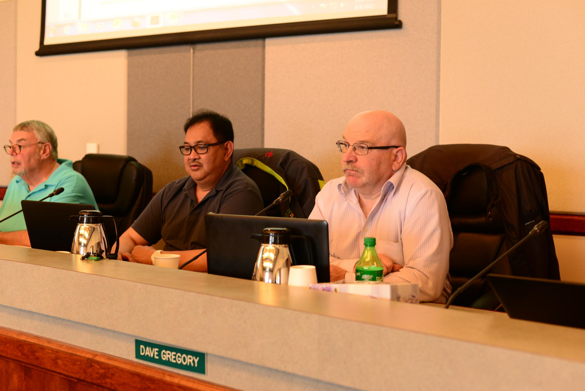City Councilors Alejandro “Bong” Tungul, center, and Dave Gregory, right, acknowledged the investigation at the Oct. 24 meeting of the Unalaska City Council. Tungul said he’s received a warrant targeting his emails. (Photo by Berett Wilber/KUCB)