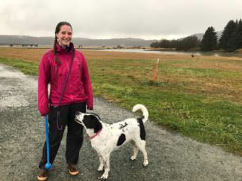 Courtney Wendel and her dog, Kiska, on the Airport Dike Trail. Wendel helped to get a second dumpster placed on the trail to help keep it clean.
