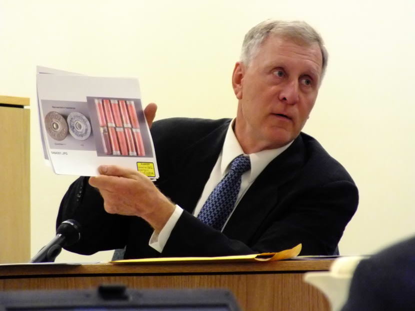Retired firearms and toolmark forensics examiner Robert Shem shows photographic comparisons of 12-gauge shotgun shells or cartridges that were found in Christopher Strawn’s trailer during his homicide trial on Oct. 13, 2017.