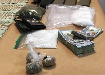 Methamphetamine, heroin and cash seized in a Tuesday night drug bust are seen on display at the Ketchikan Police Department. (Photo by Leila Kheiry/KRBD )
