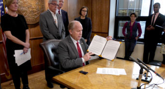 Alaska Gov. Bill Walker shows off the freshly signed Administrative Order 289 in the state Capitol on Oct. 31, 2017. The order establishes the Alaska Climate Change Strategy and Climate Action for Alaska Leadership Team. (Photo by Skip Gray/360 North)