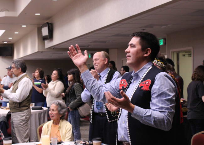 Ethel Lund, Gov. Bill Walker and Sealaska President and CEO Anthony Mallott react to performances at the Indigenous Peoples Day celebration at Elizabeth Peratrovich Hall on Oct. 9, 2017. (Photo by Adelyn Baxter)