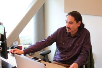 James Dommek Jr. is the sole operator for Rising Indigenous Voices Radio, or RIVR. RIVR was launched in September and can be streamed at therivr.net. (Photo by Samantha Davenport/Alaska Public Media)