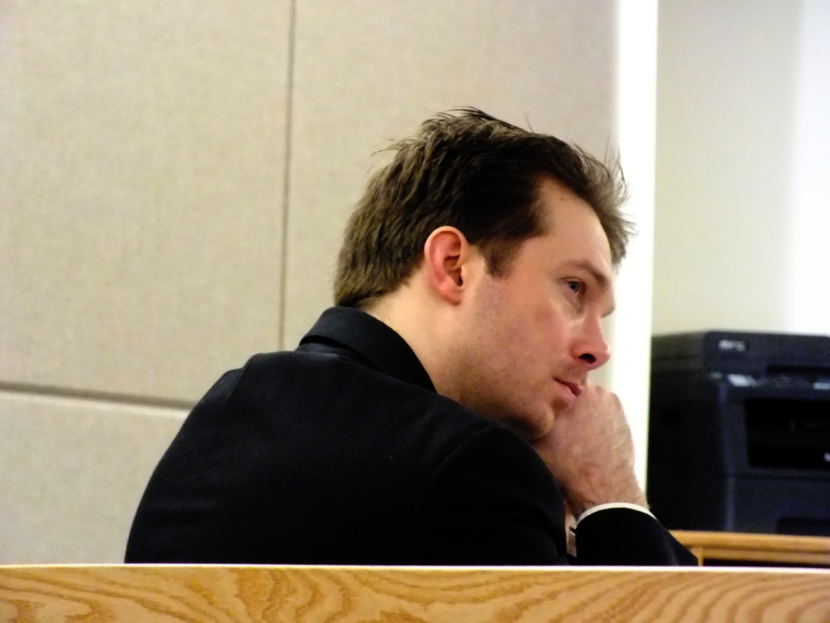 Christopher Strawn listens to a 911 call playback during his trial Oct. 5, 2017 in Juneau Superior Court. (Photo by Matt Miller/KTOO)