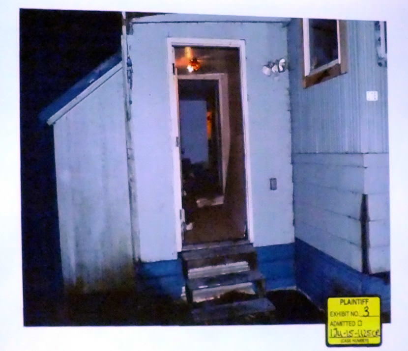 Photo of entry way of the mobile home at C-16 Kodzoff Acres Trailer Park is presented as evidence during the Christopher Strawn trial on Oct. 6, 2017. (Photo by Matt Miller/KTOO)