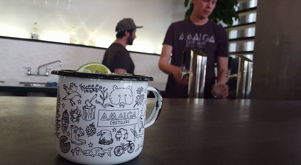 Amalga Distillery employees in Juneau serve up a cocktail in their tasting room in May 2017.