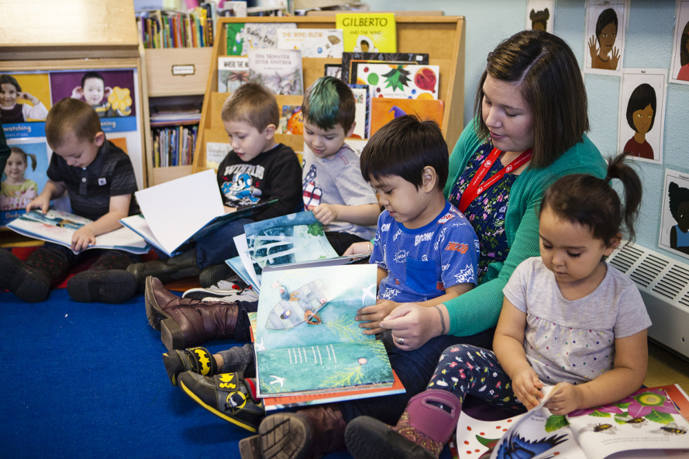 Tlingit & Haida Head Start teacher Kayla Tripp and her class look through six new Baby Raven Reads books Oct. 20, 2017, after they were delivered by Sealaska Heritage Institute staff. (Photo by Nobu Koch/courtesy Sealaska Heritage)