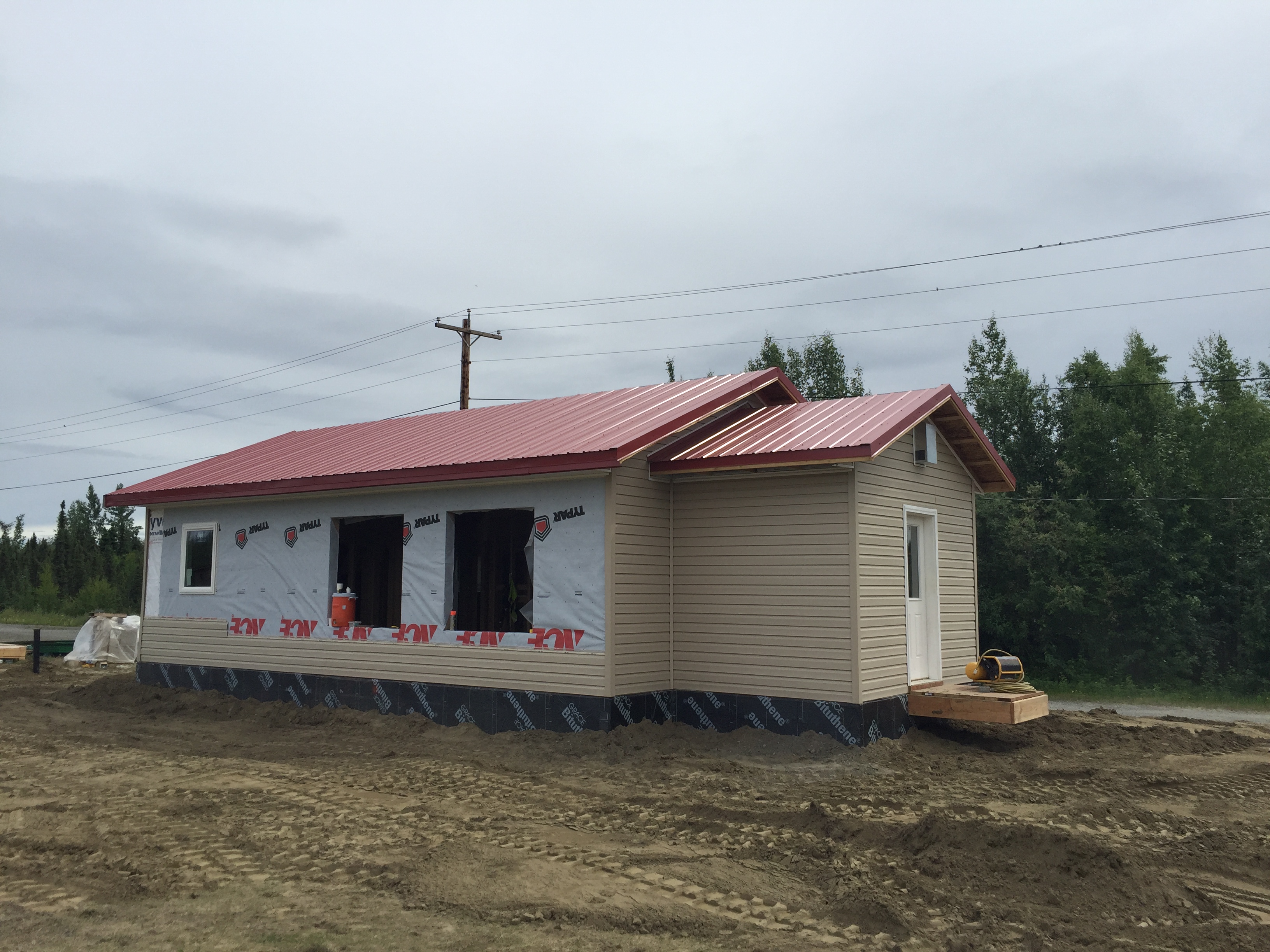 New teacher housing being built by high school students in Nikolai, Alaska in June. (Photo by Anne Hillman/Alaska Public Media)