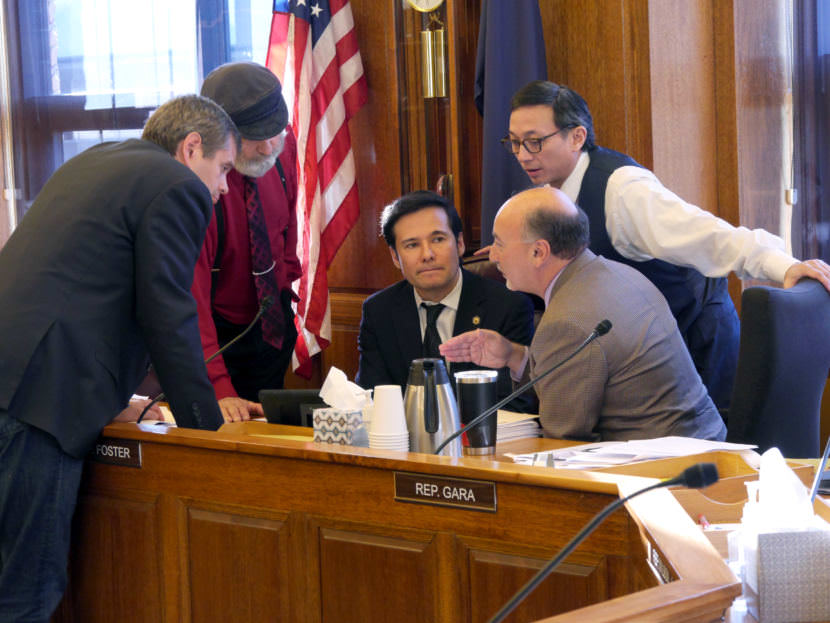 Alaska House majority members Reps. Chris Tuck, left, D-Anchorage; Co-Chair Paul Seaton, R- Homer; Co-Chair Neal Foster, D-Nome; Les Gara, D- Anchorage; and Scott Kawasaki, D- Fairbanks, huddle during Finance Committee discussions about amendments to Senate Bill 54. If passed, the bill would amend Senate Bill 91, a major but controversial reworking of Alaska criminal justice laws passed last year. (Photo by Skip Gray/360 North)