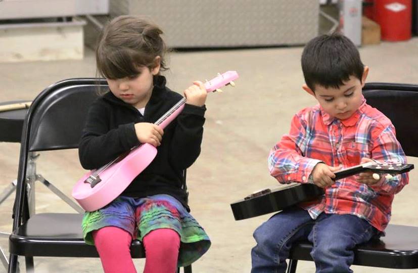 Students from Hollis School practice playing ukuleles. The school recently had visiting music teachers from Alaska-based non-profit Dancing with the Spirit. (Photo courtesy Hollis School)
