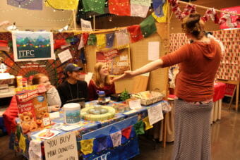 Kayla Simpson, Miguel Cordero and Mary Landes, members of Juneau Teens for Change sell treats and homemade goods at the 2017 Public Market. (Photo by Adelyn Baxter/KTOO)
