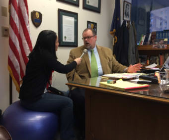 KTOO reporter Lisa Phu interviews District Attorney James Scott in January 2015 after he dropped the case against a Juneau woman for tripping traps. Scott's picture of Abraham Lincoln can be seen in the upper right.