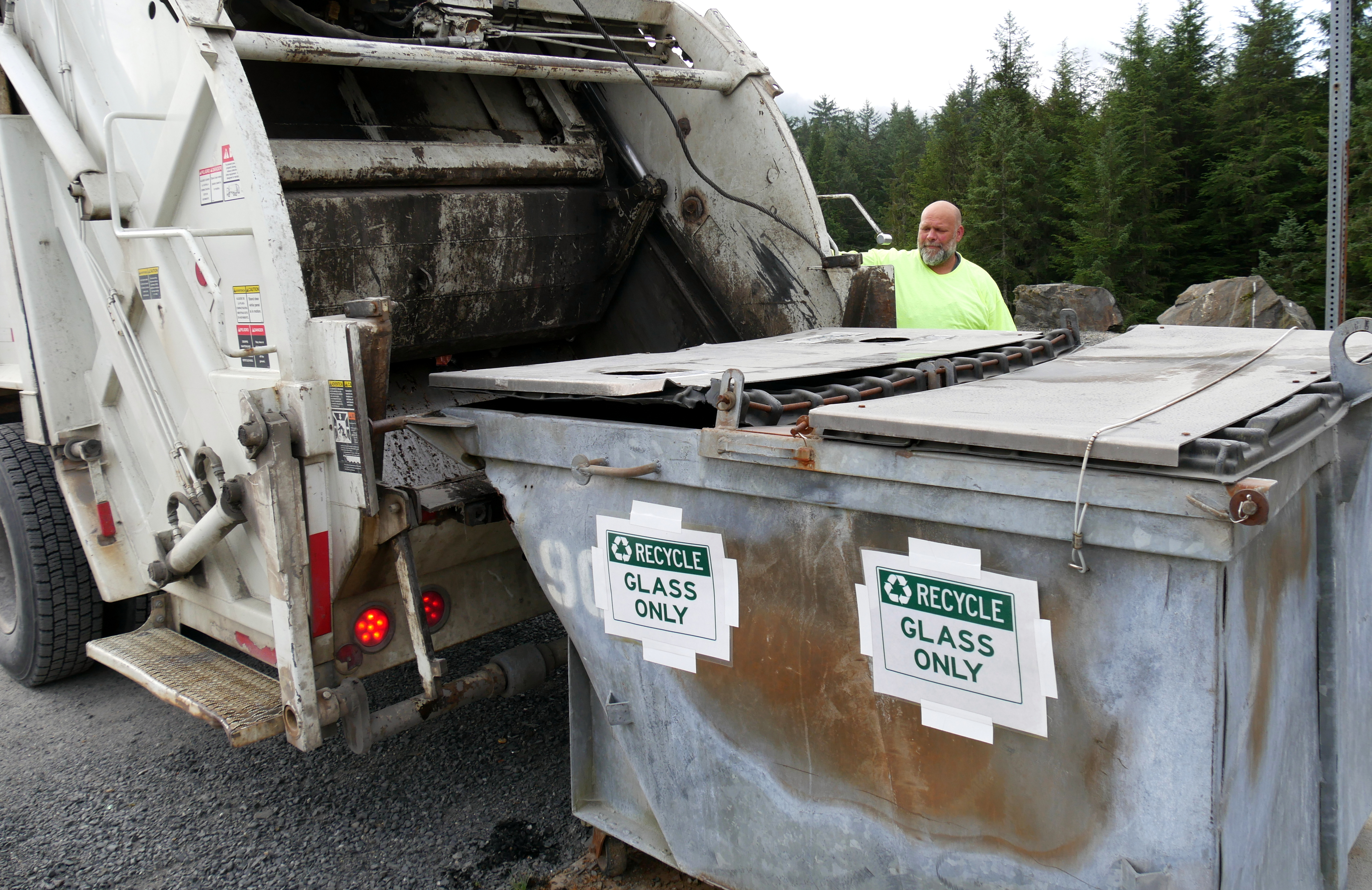 Petersburg Public Works employee, Kevin Granberg, loads glass into a dump truck to take to the landfill. (Photo by Angela Denning/KFSK)
