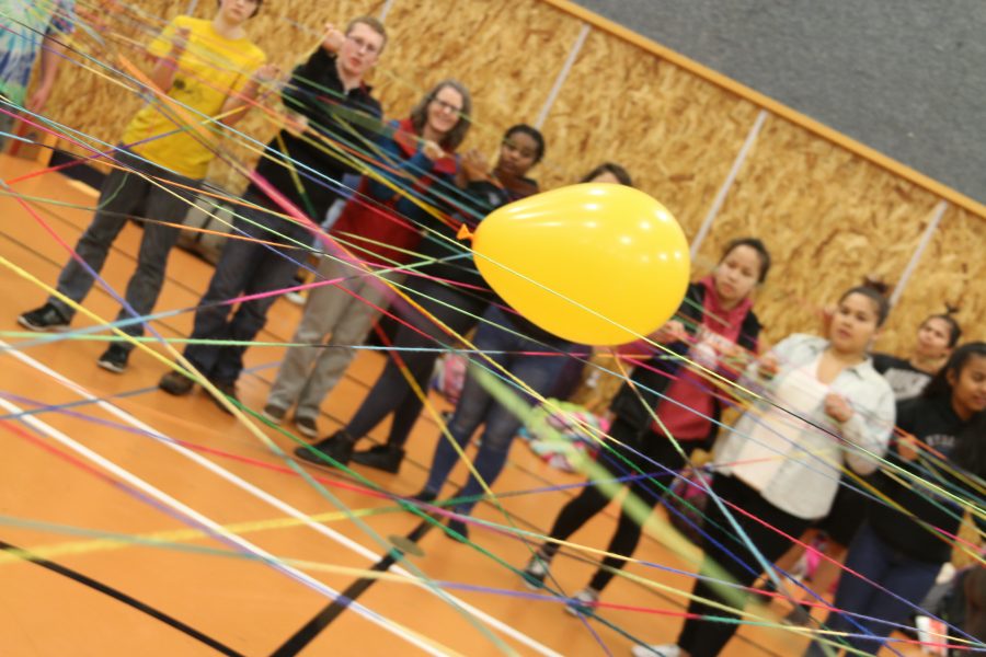 Students participate in a Phlight Club event. The colored strings represent a students’ web of support. (Photo courtesy Amy McDonald)