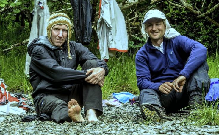 The secret is in the feet. Dan Evans, 56, left, and Eric Speck, 48, relied on “game wisdom” to find routes through the rugged valleys of Baranof Island. But they also applied common sense: They built large fires almost every night (even in the rain) to dry out their boots. (Photo courtesy Dan Evans)