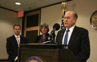 Alaska Gov. Bill Walker talks about his budget proposal in Anchorage on Dec. 15, 2017, as Revenue Commissioner Sheldon Fisher and budget director Pat Pitney look on. The budget for the fiscal year that begins in July 2018 would draw from Permanent Fund earnings. (Photo by Wesley Early/Alaska Public Media)