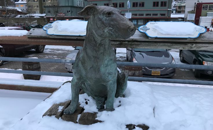 The statue of Patsy Ann, once named Juneau's official greeter, watches the downtown waterfront in December 2017. The Friends of Patsy Ann commissioned the famous bull terrier's statue, which was presented in July 1992. (Photo by Julia Caulfield/KTOO)