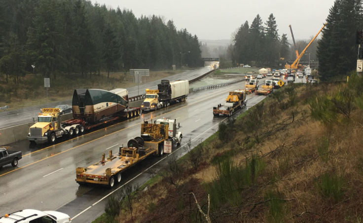 Heavy lift cranes have removed the two Amtrak rail cars that were dangling over the lanes of southbound I-5 from a railroad overpass in DuPont, Washington. (Photo by Tom Banse/Northwest News Network)