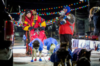 Mitch Seavey pulls his team past the finish line after officially checking off the Iditarod Trail. (Photo by David Dodman/KNOM)