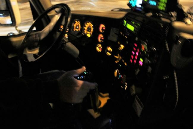 A view inside the cab of a DOT plow truck, where an array of controls allow the driver to adjust their plow level and release brine or sand onto the road as they drive. (Photo by Adelyn Baxter/KTOO)