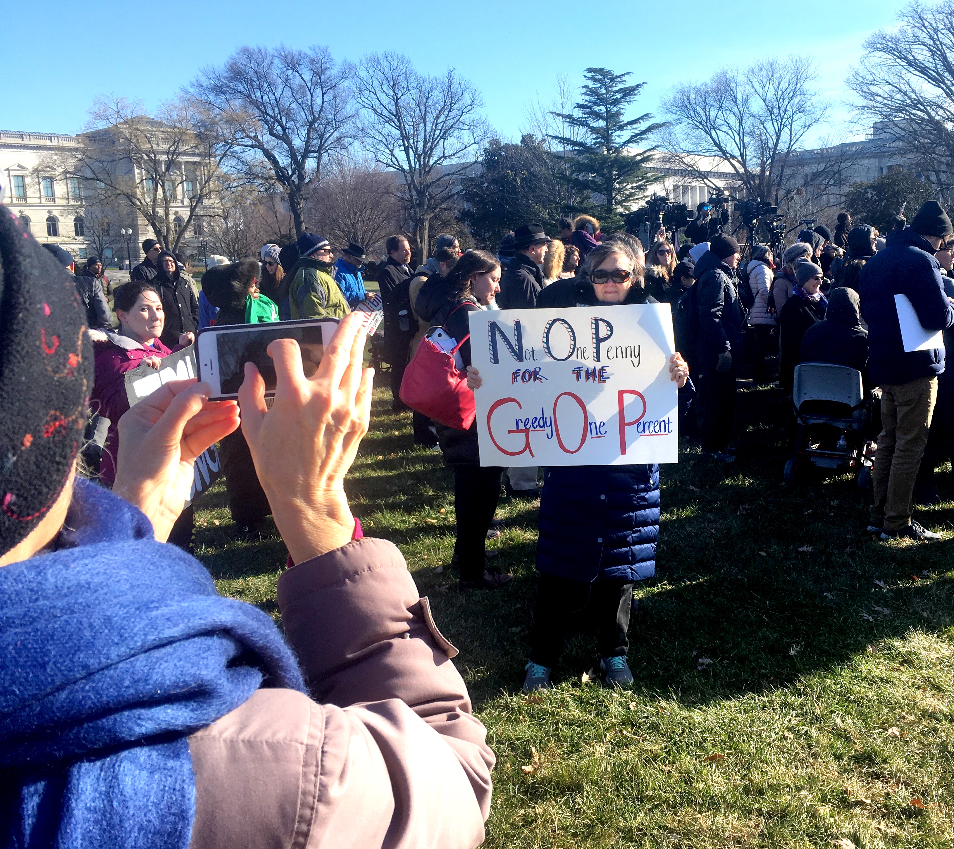 A crowd gathered outside the U.S. Capitol to protest the Republican tax bill. (Photo by Liz Ruskin/Alaska Public Media)