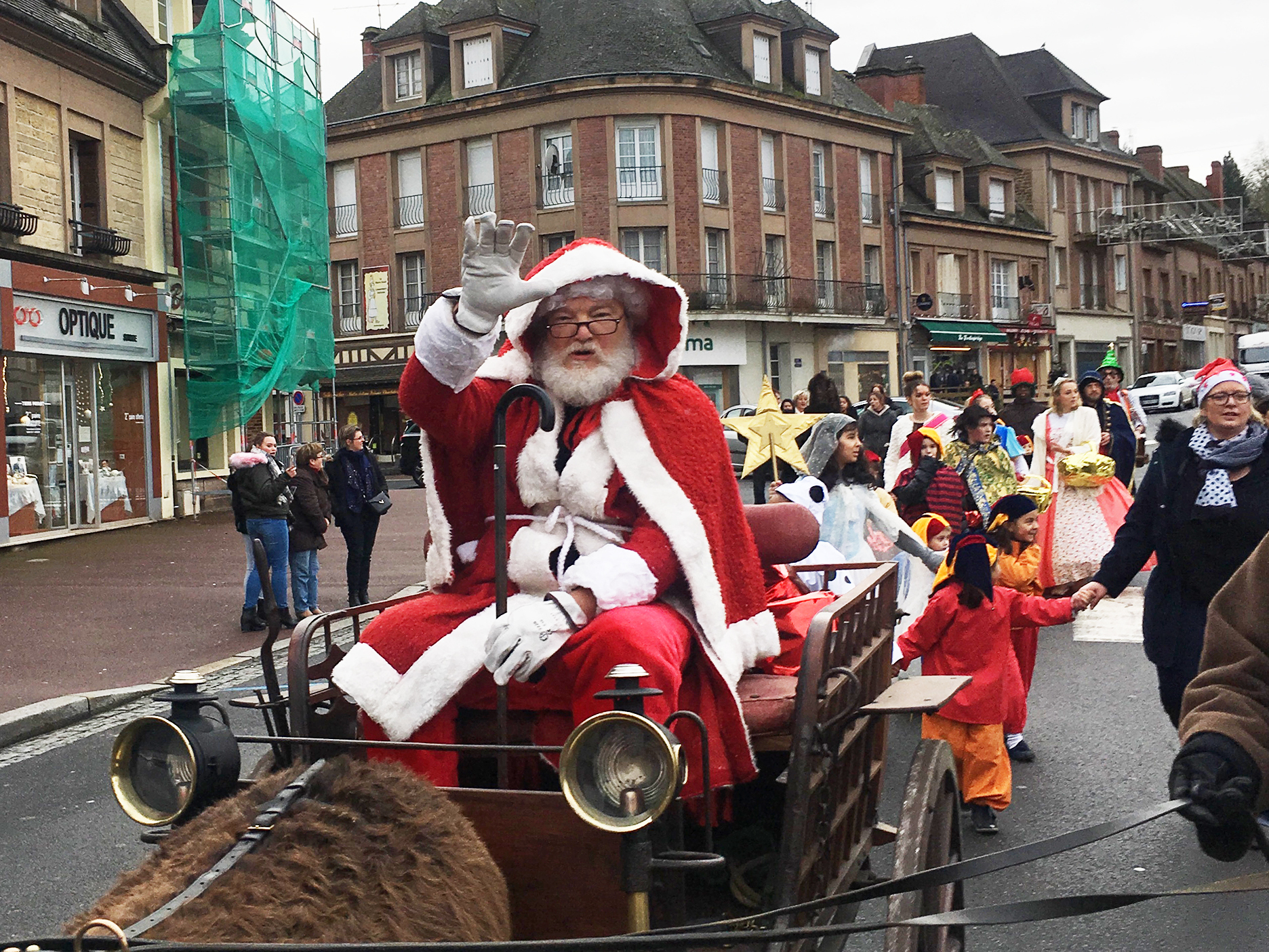 Retired American photographer Tom Haley, 66, portrays Santa during a pageant in Normandy. (Photo by Eleanor Beardsley/NPR)