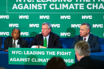New York City Mayor Bill de Blasio, center, announced that the city is suing five major oil companies over climate change. The city also announced it will divest from companies owning fossil fuel reserves. (Photo courtesy of New York City Mayor's Office)