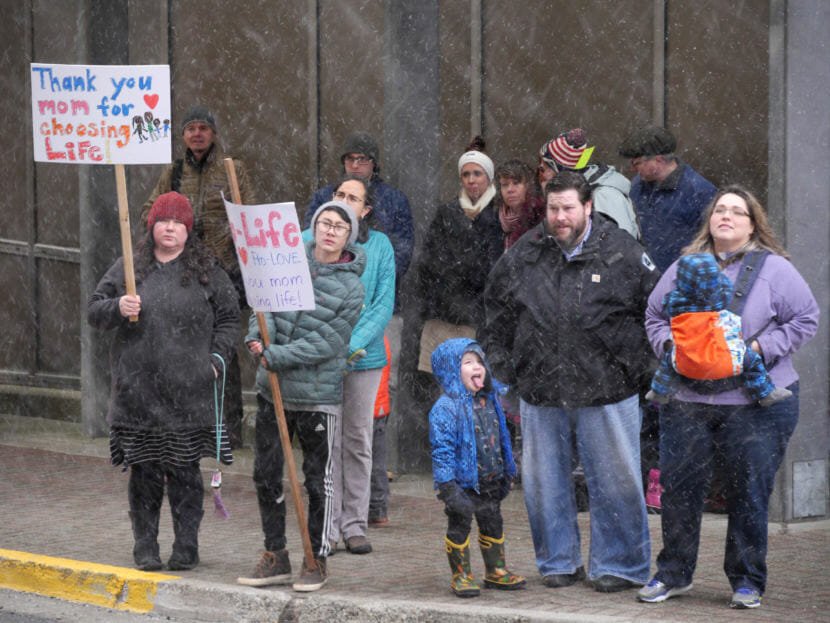 A crowd holds an anti-abortion rally outside the Alaska State Capitol on Monday, Jan. 22, 2018. The group Alaskans for Life organized the event. (Photos by Skip Gray/360 North)
